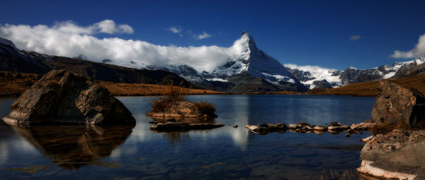 Scenic view of lake and mountains against sky