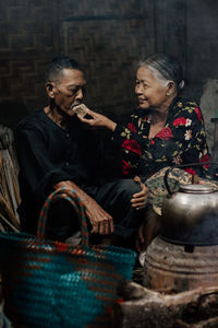 Portrait of smiling friends sitting at market