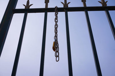 Low angle view of chain hanging against sky