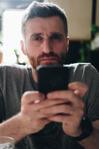 Portrait of man using mobile phone