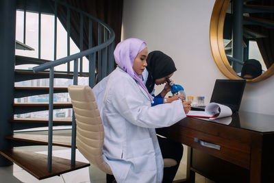 Side view of woman working on table