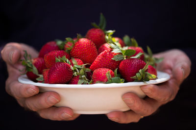 Close-up of strawberries over red background