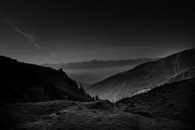 Scenic view of mountains against sky at dusk