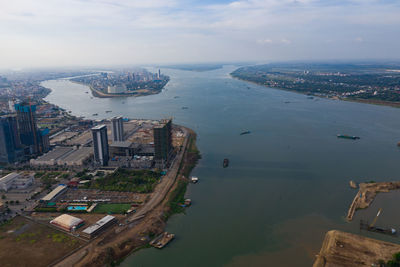 High angle view of buildings by sea against sky