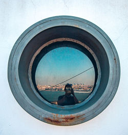 Reflection of man photographing in glass