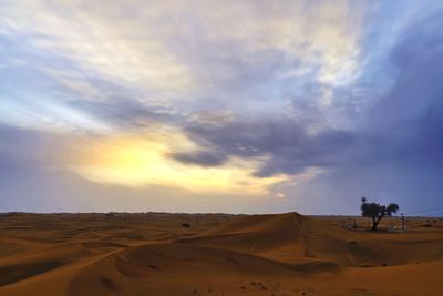 Scenic view of desert against sky during sunset