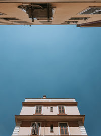 Low angle view of building against clear blue sky