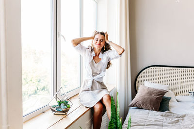 Young woman relaxing on bed at home