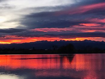 Scenic view of lake against orange sky