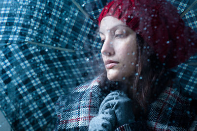 Portrait of young woman in rain
