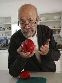 Young man holding apple