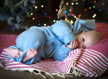 Full length of cute baby relaxing on bed