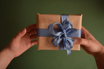 Cropped hand of woman holding gift box