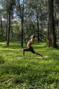 Man seen up close, without shirt doing stretches on yoga mat, exercise, latin america