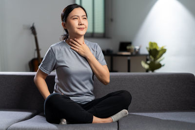 Portrait of young woman exercising at home