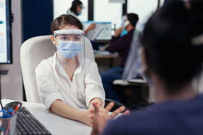 Portrait of doctor examining patient at clinic