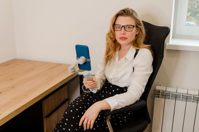Portrait of attractive young girl taking selfie on smartphone