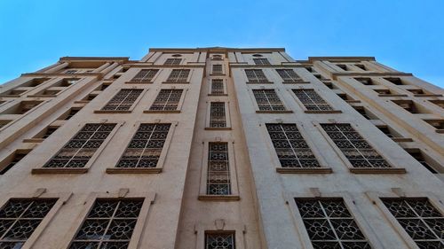 Low angle view of building against blue sky