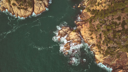 High angle view of rocks in sea