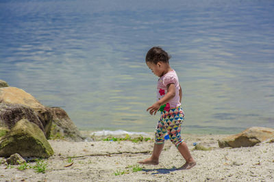 A child walks on the edge of lake toba