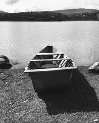 Boat moored on beach against sky