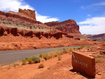 Empty road by rock formation in capitol reef national park