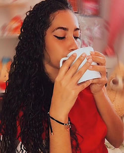 Young woman drinking water from coffee