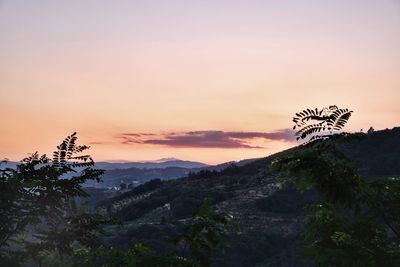 Scenic view of silhouette mountains against sky at sunset