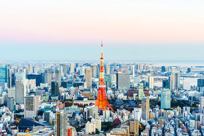 Aerial view of buildings in city against sky