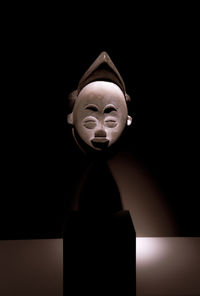 Close-up of statue against black background