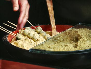 Human hand touching food in container