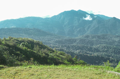 Scenic view of landscape and mountains against sky
