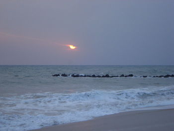 Scenic view of sea against clear sky during sunset