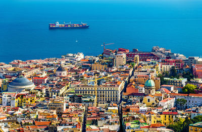 High angle view of sea and buildings in city