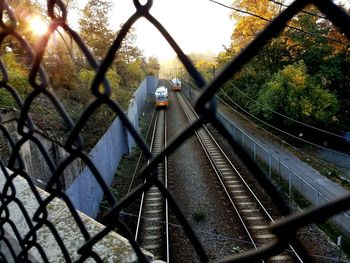 Railroad track seen through chainlink fence