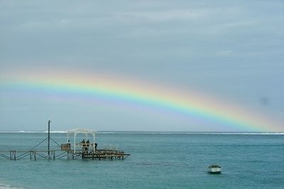 Scenic view of rainbow over calm sea