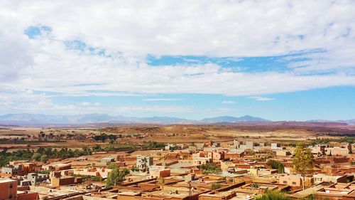 High angle view of houses in town against sky