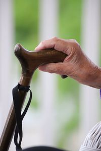 Cropped senior hand of person holding walking cane