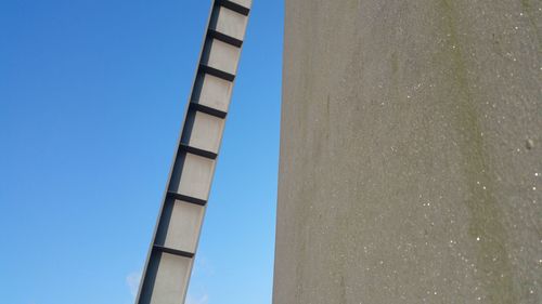 Low angle view of built structure against blue sky