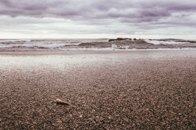 Surface level of beach against sky