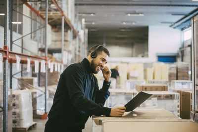 Young man using mobile phone in office