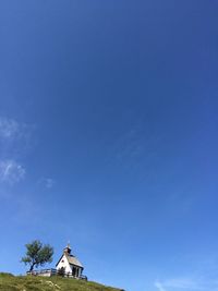 Low angle view of cross against blue sky