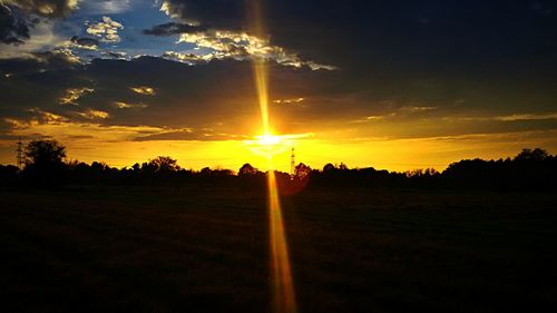 Scenic view of field against sky during sunset