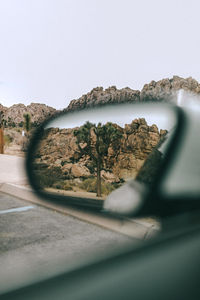 Close-up of view seen through side-view mirror