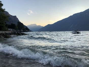 Scenic view of sea and mountains against sky