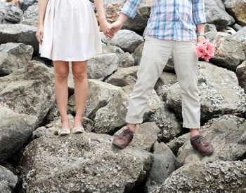 Low section of people standing on rock
