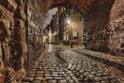 Footpath amidst buildings in city