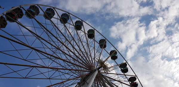 Low angle view of ferris wheel against sky