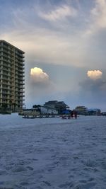 Buildings in city against sky during sunset