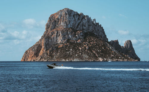 Scenic view of sea and mountain against sky